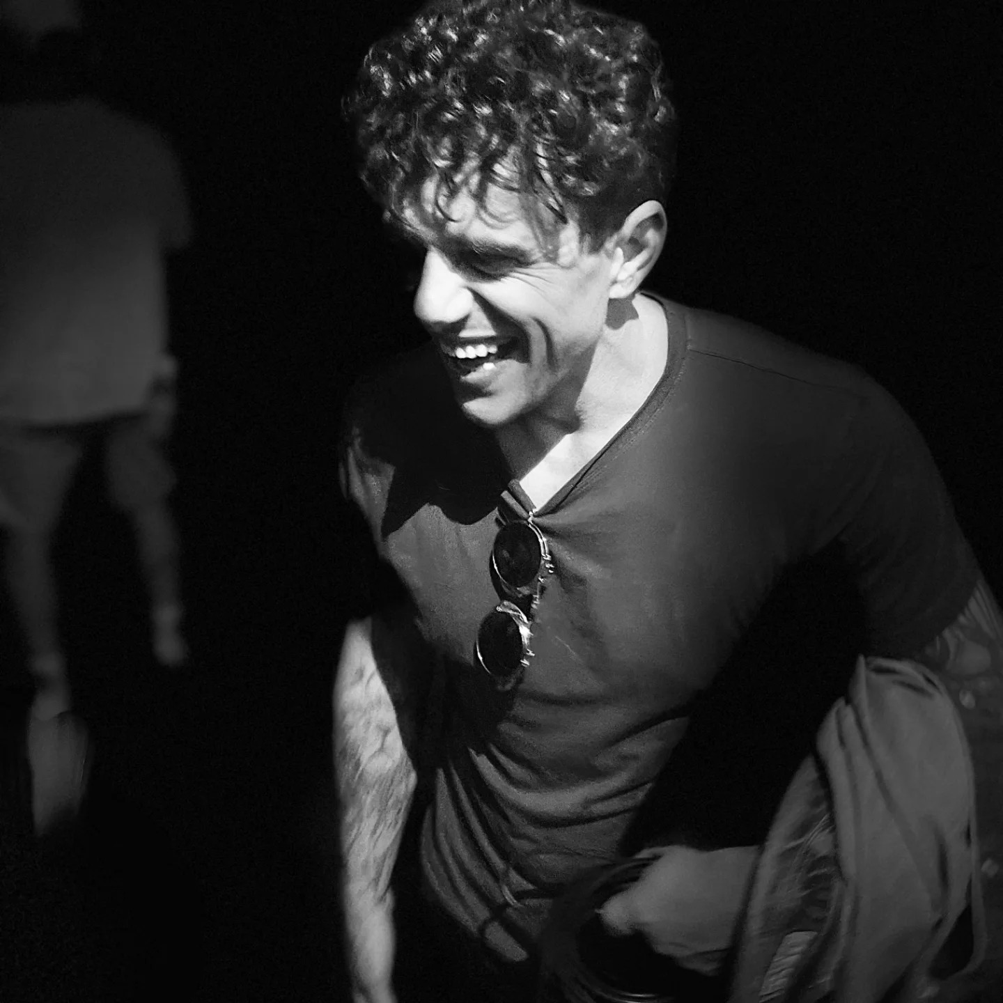 Duane Joaquim, founder of Concept Inc., laughing at a live event in black and white